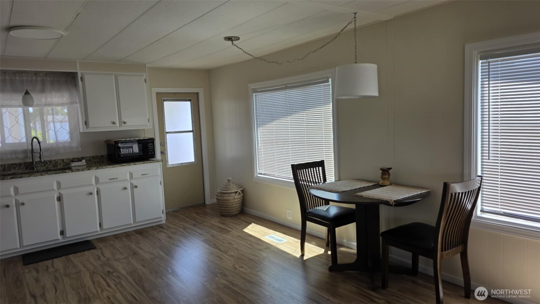 207 Ho Hum Lane Aberdeen, WA 98520 - Photo 12 of 22 a kitchen with granite countertop white dining table chairs cabinets and stainless steel appliances