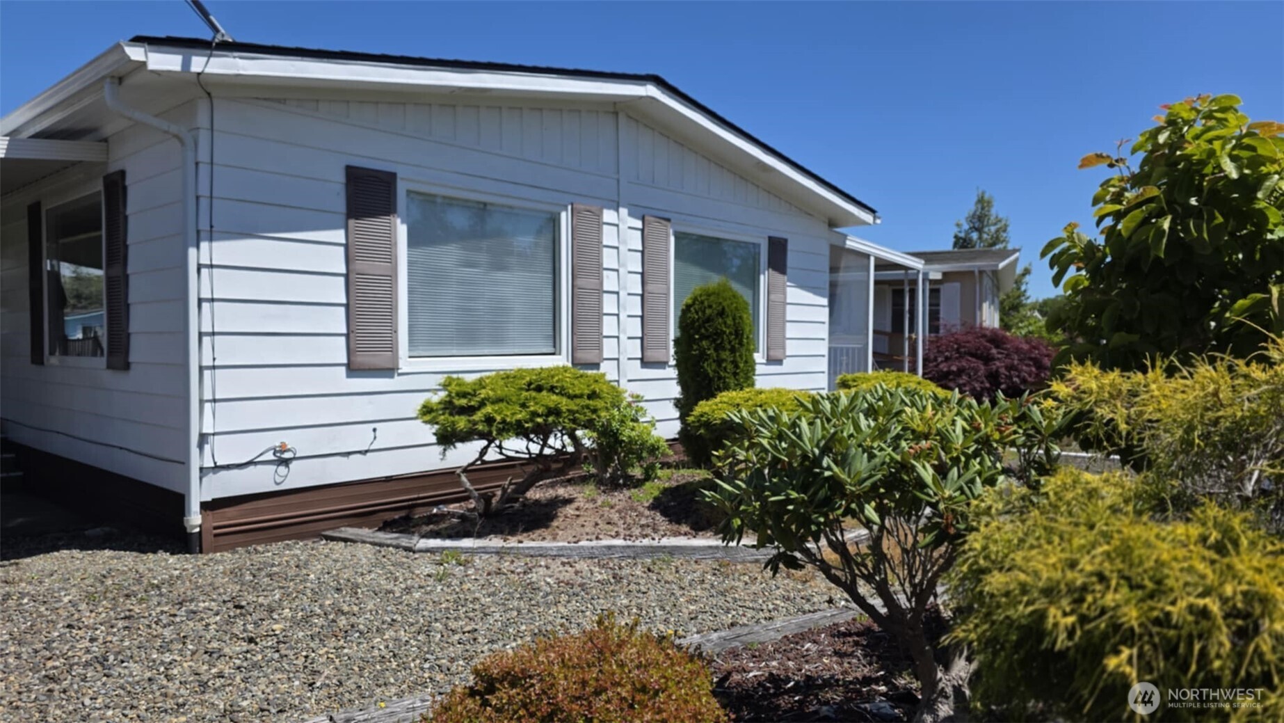 207 Ho Hum Lane Aberdeen, WA 98520 - Photo 2 of 22 a view of a house with a flower garden