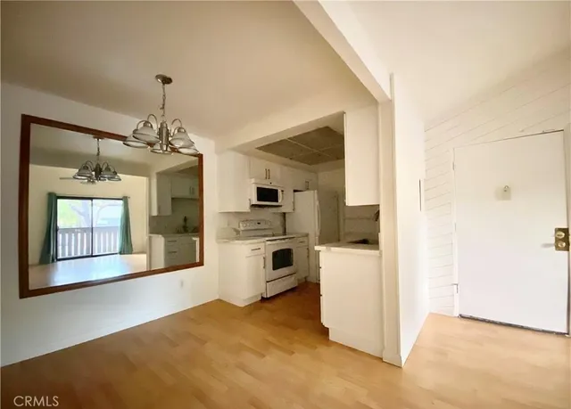 a view of a kitchen with a refrigerator a stove top oven and a refrigerator