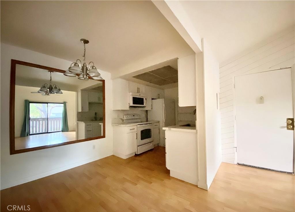 20702 El Toro Road, Unit 168 Lake Forest, CA 92630 - Photo 2 of 16 a view of a kitchen with a refrigerator a stove top oven and a refrigerator