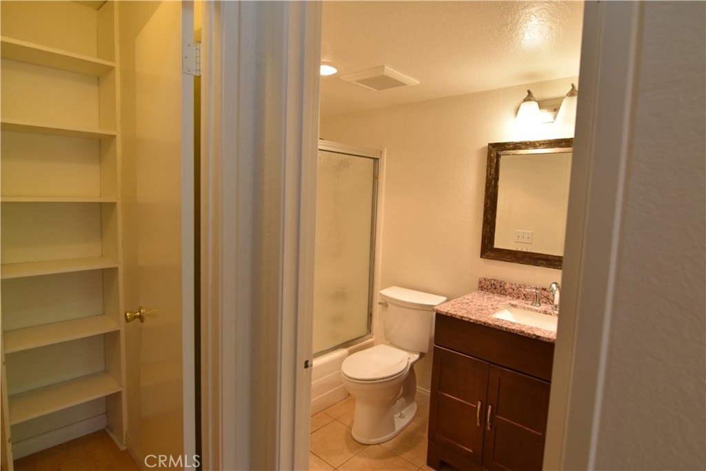20702 El Toro Road, Unit 168 Lake Forest, CA 92630 - Photo 9 of 16 a bathroom with a granite countertop sink toilet and mirror