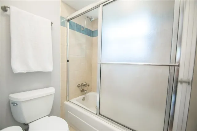 a white toilet sitting next to a bathroom sink