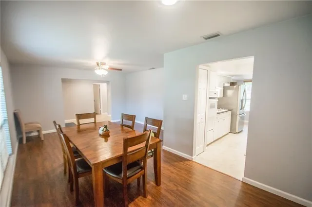 a view of a dining room with furniture and wooden floor