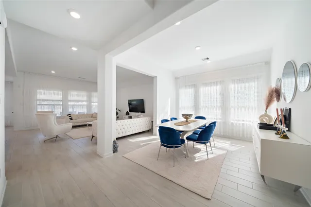 a living room with furniture a large window and a table