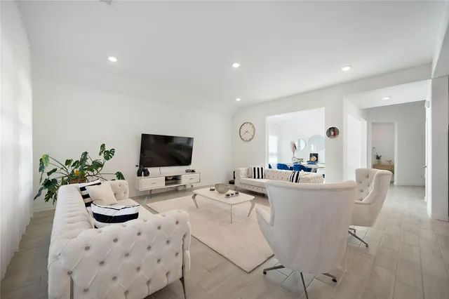 a living room with furniture and flat screen tv