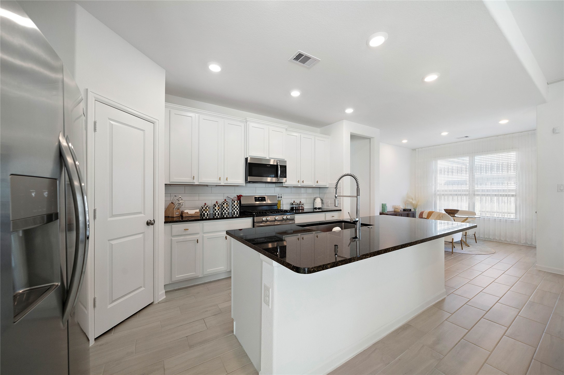 2239 Ginger Trail Lane Rosenberg, TX 77469 - Photo 18 of 35 a kitchen with stainless steel appliances granite countertop a sink and refrigerator