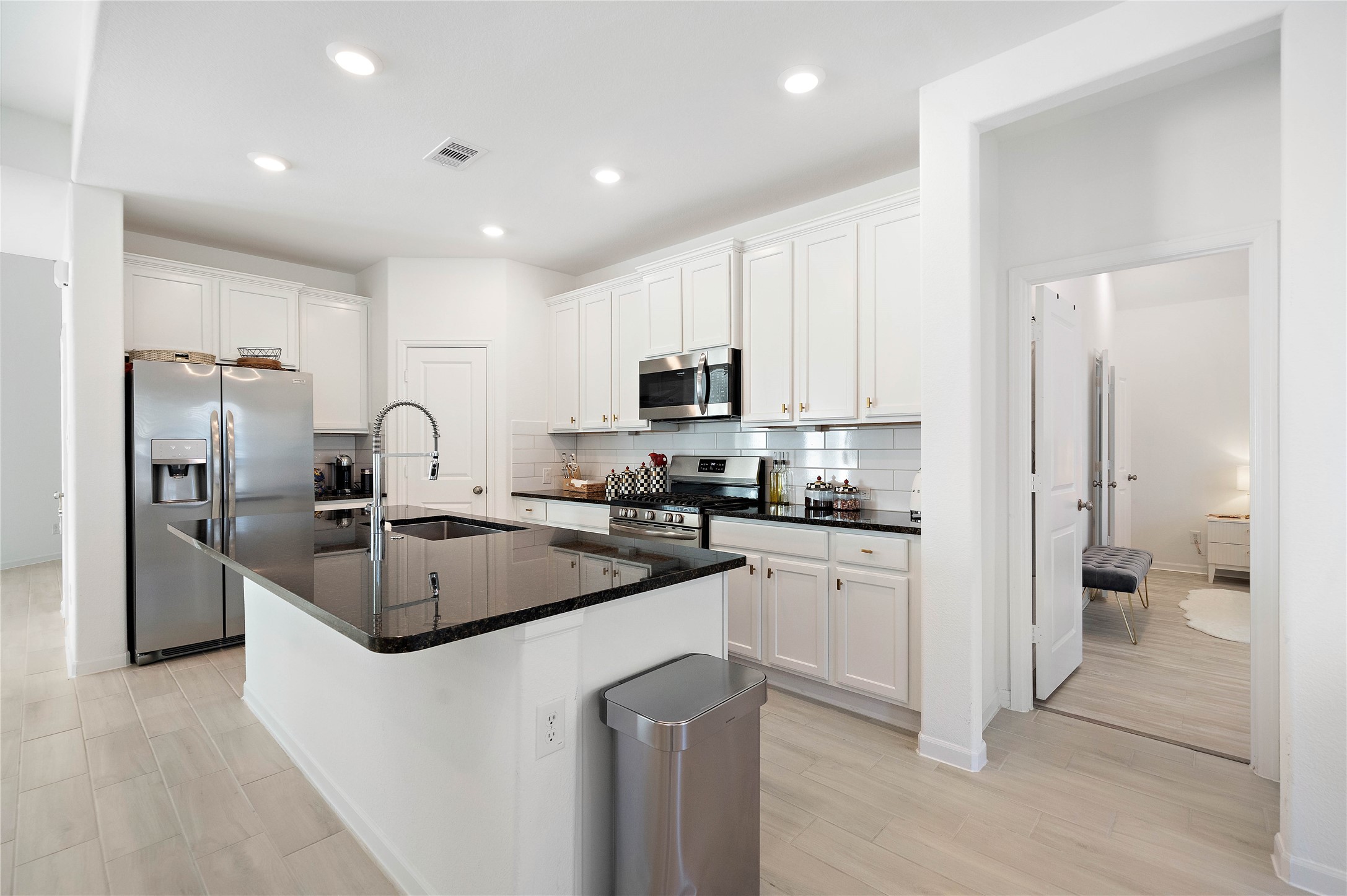 2239 Ginger Trail Lane Rosenberg, TX 77469 - Photo 19 of 35 a kitchen with stainless steel appliances granite countertop a stove a sink and a refrigerator
