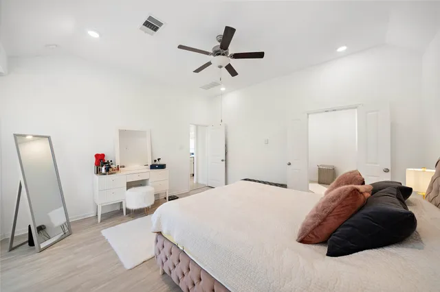 a bedroom with a bed and a ceiling fan