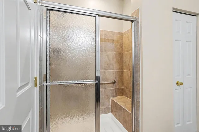 a bathroom with a glass shower door