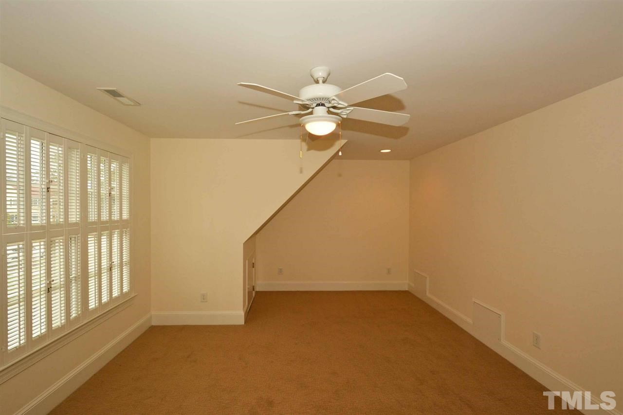 1314 Canterbury Road Raleigh, NC 27608 - Photo 19 of 23 an empty room with a window and a ceiling fan