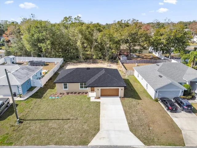 an aerial view of a house with a yard