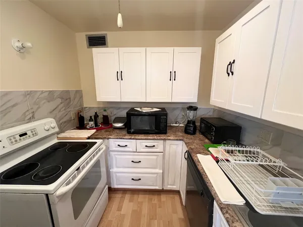 a kitchen that has a sink and a stove