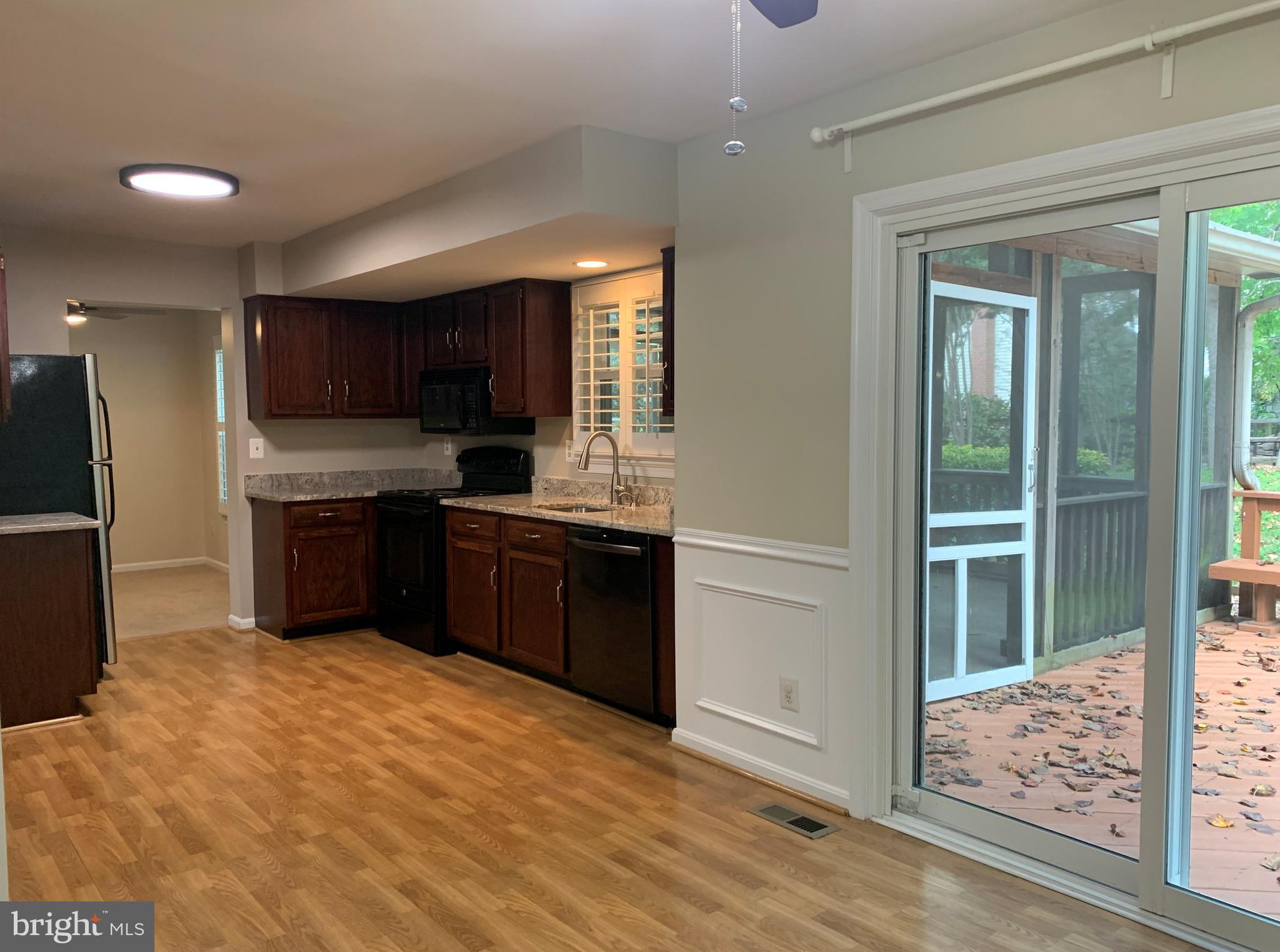 5606 Light Infantry Drive Burke, VA 22015 - Photo 17 of 66 a kitchen with stainless steel appliances granite countertop a stove a sink and a refrigerator