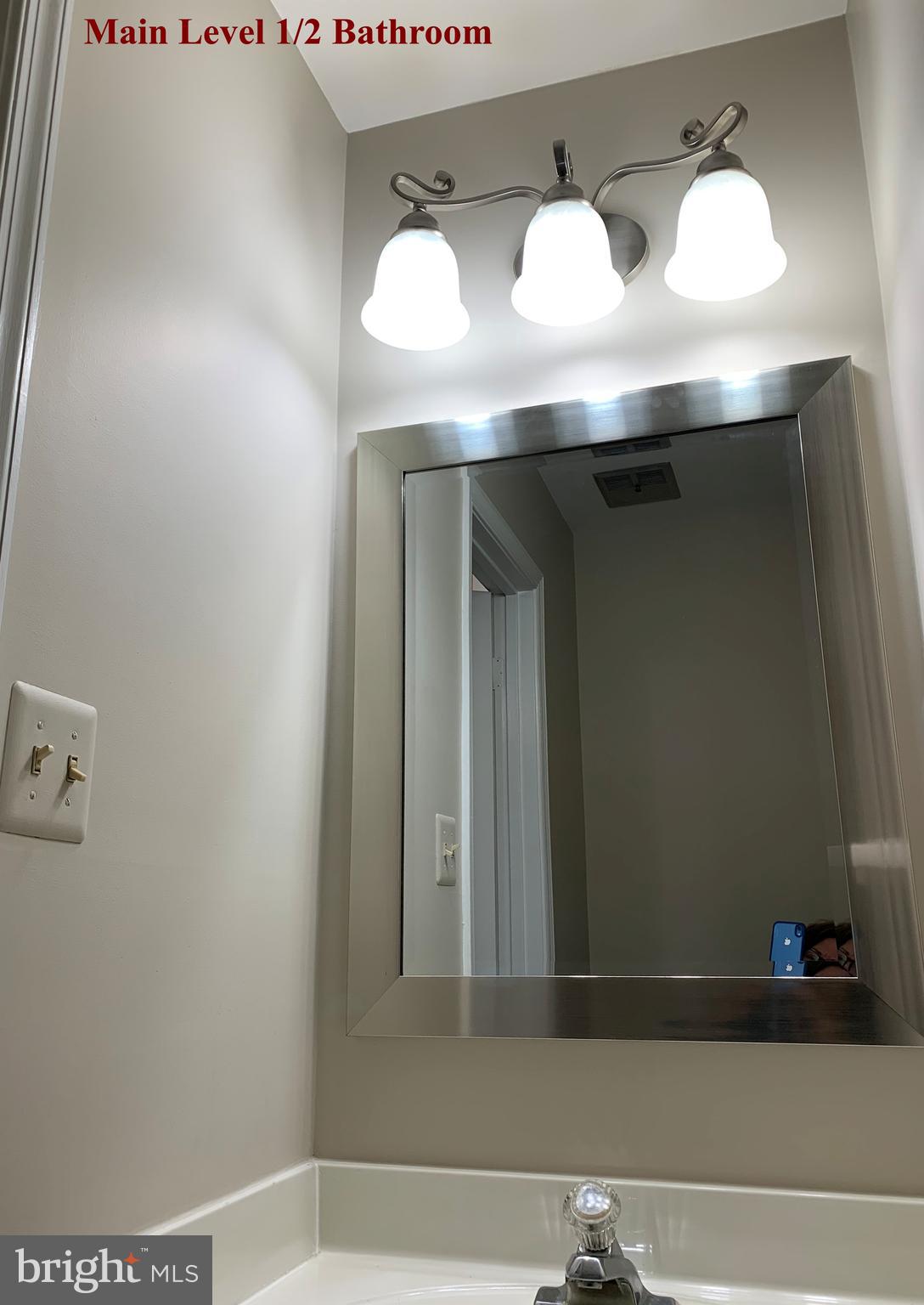 5606 Light Infantry Drive Burke, VA 22015 - Photo 24 of 66 a bathroom with a sink and a mirror