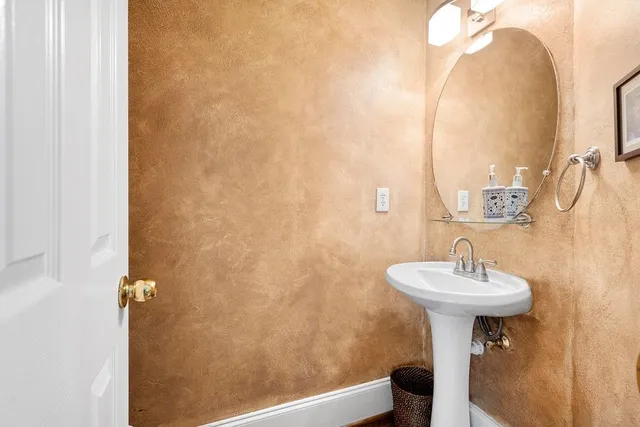 a bathroom with a sink a mirror and a vanity