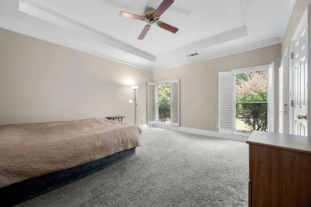 a bed room with a bed and a large window