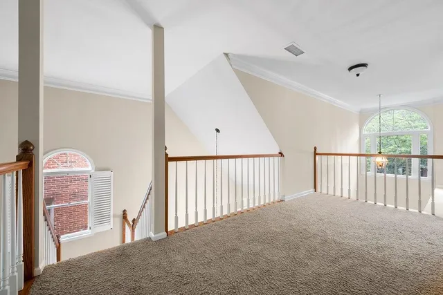 a view of a hallway with windows