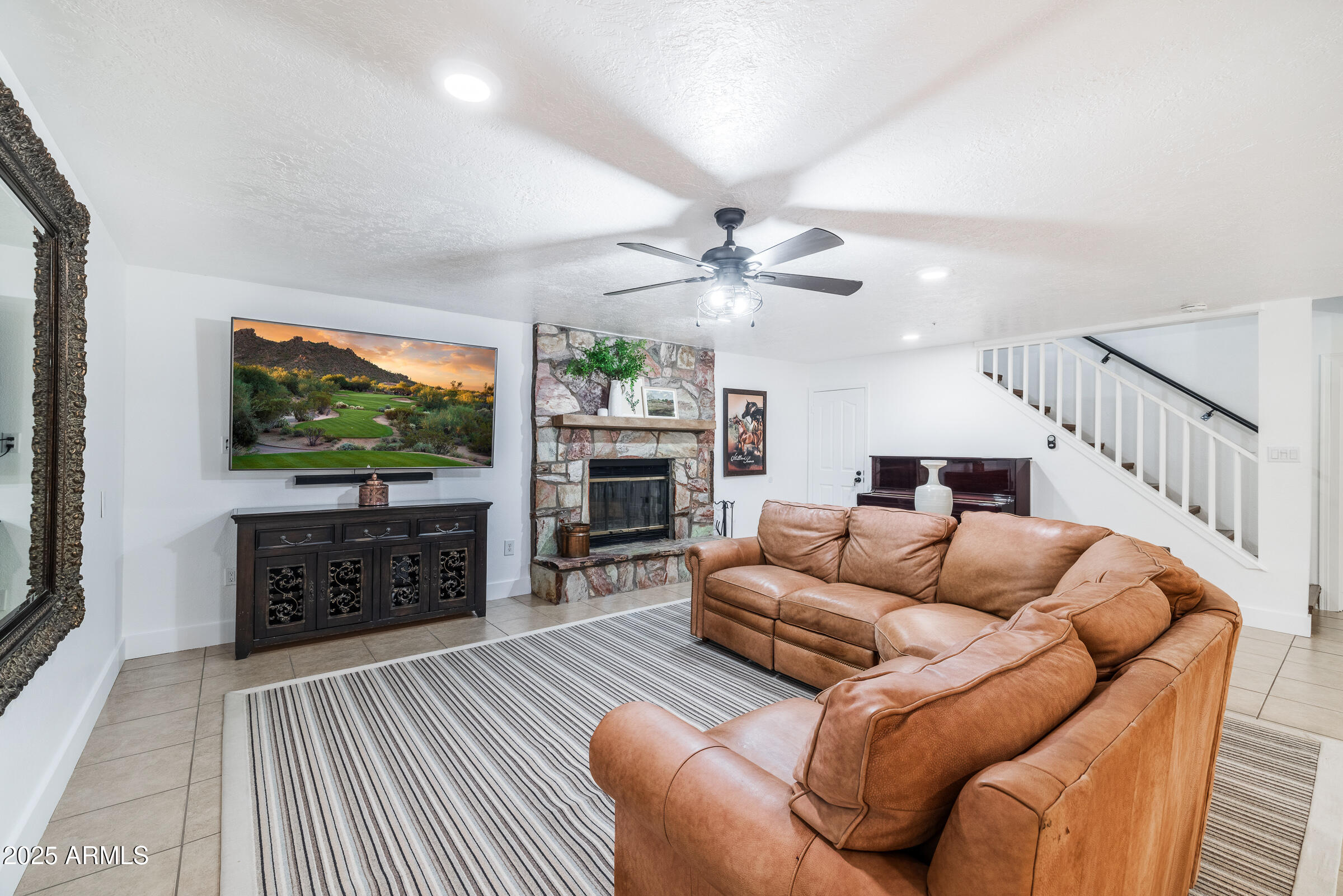 6835 East Peak View Road Scottsdale, AZ 85266 - Photo 62 of 107 a living room with furniture a flat screen tv and a fireplace