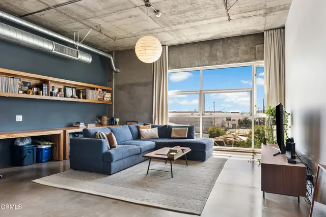 a living room with furniture and a floor to ceiling window
