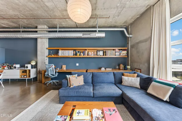 a view of a living room with large windows