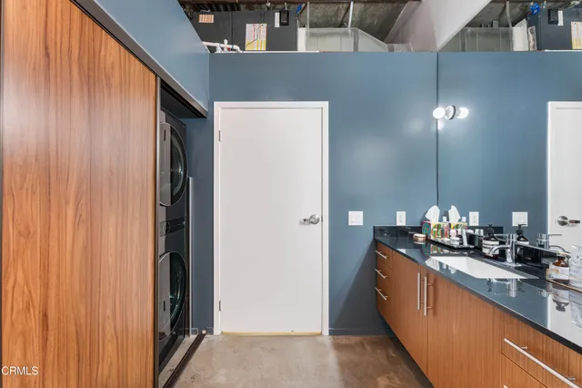 a kitchen with kitchen island a counter top space a sink and cabinets