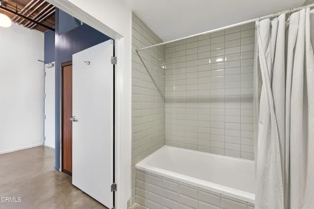 a bathroom with a bathtub and shower