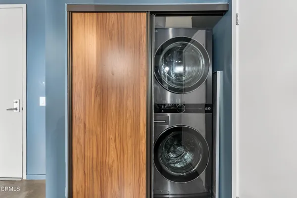 a view of a hallway with washer and dryer