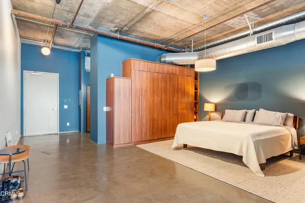 a bedroom with a bed and a table