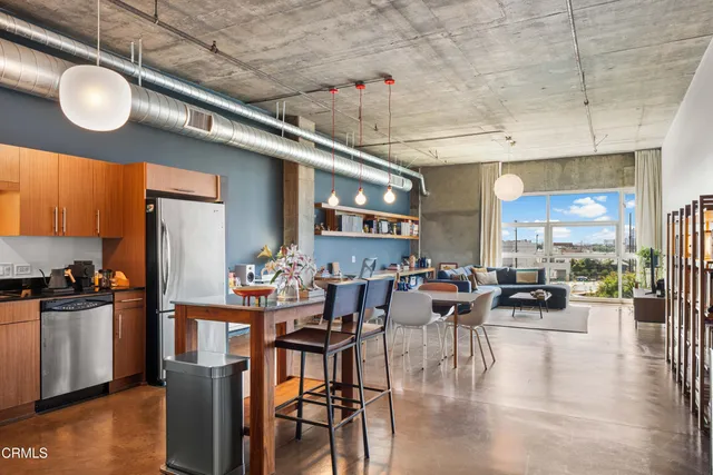 a very nice looking living room with dining room and wooden floor