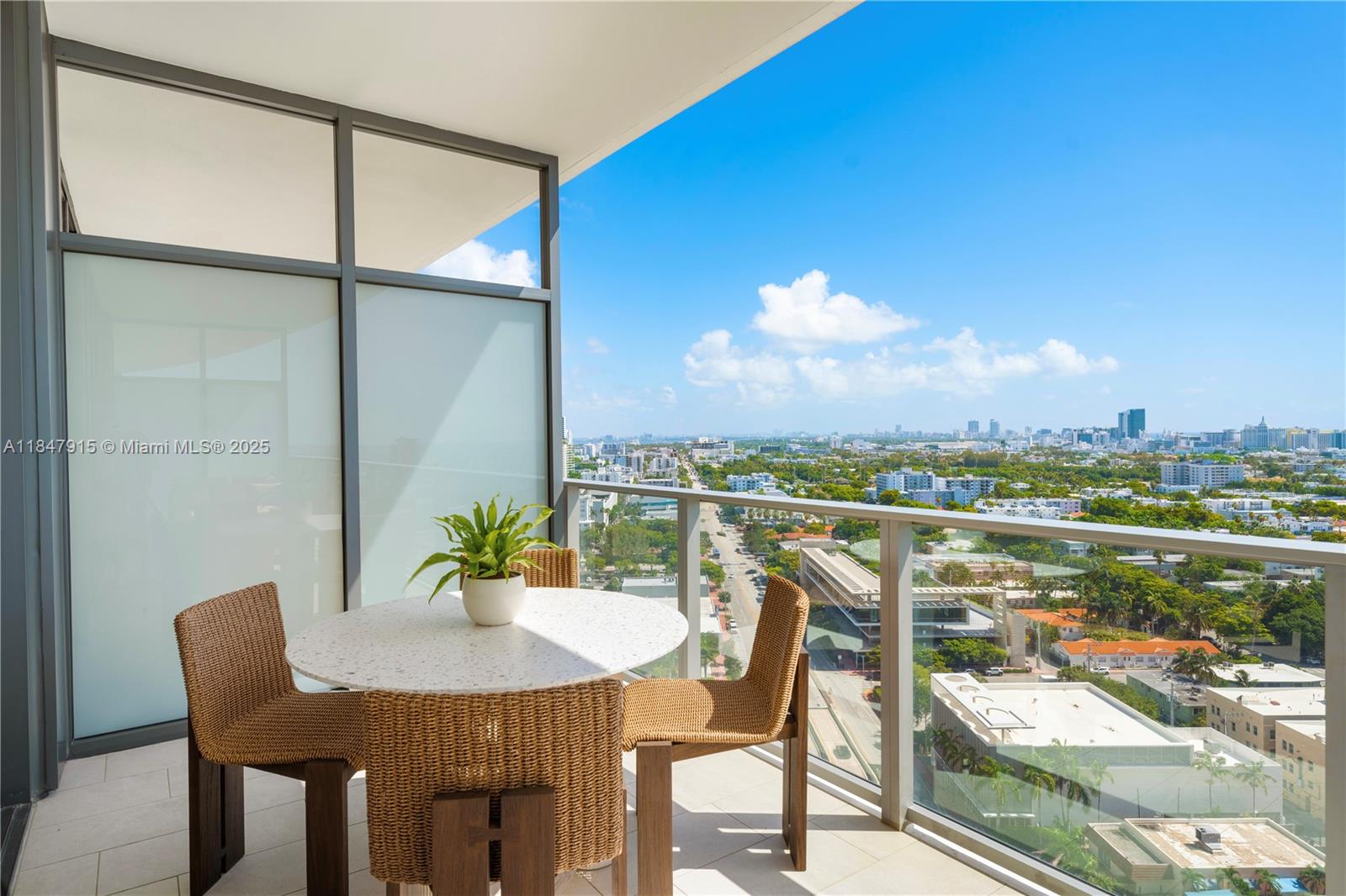 500 Alton Road, Unit 2008 Miami Beach, FL 33139 - Photo 11 of 48 a view of a balcony with table and chairs