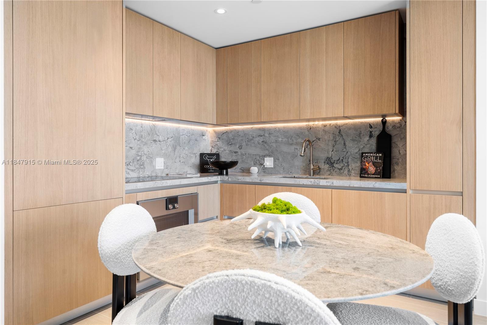 500 Alton Road, Unit 2008 Miami Beach, FL 33139 - Photo 14 of 48 a kitchen with a table chairs and a granite counter top space