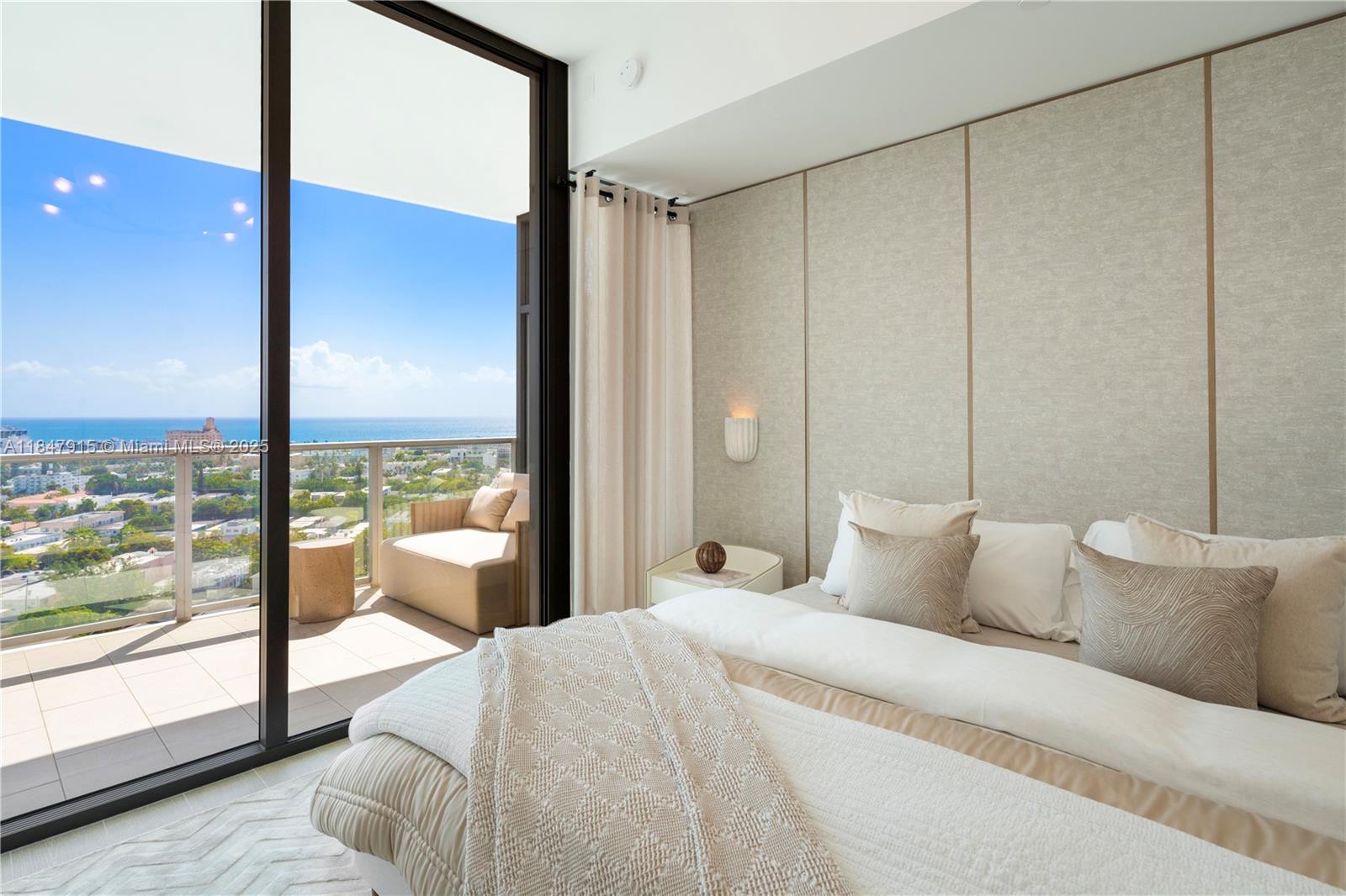 500 Alton Road, Unit 2008 Miami Beach, FL 33139 - Photo 16 of 48 a bedroom with a large window and a bed