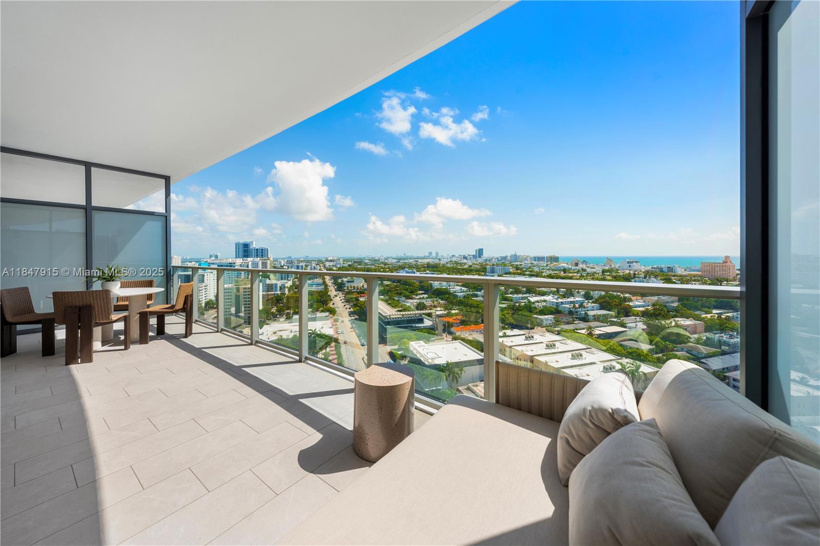 500 Alton Road, Unit 2008 Miami Beach, FL 33139 - Photo 20 of 48 a living room with couches chairs and a floor to ceiling window