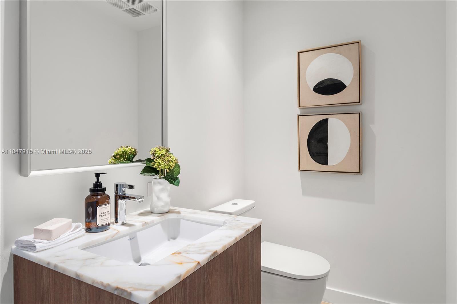 500 Alton Road, Unit 2008 Miami Beach, FL 33139 - Photo 28 of 48 a bathroom with a toilet sink and mirror
