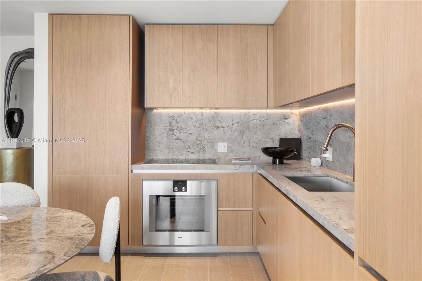 500 Alton Road, Unit 2008 Miami Beach, FL 33139 - Photo 4 of 48 a kitchen with a sink cabinets and appliances