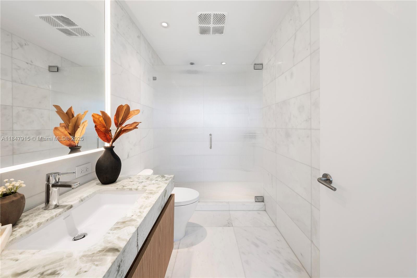 500 Alton Road, Unit 2008 Miami Beach, FL 33139 - Photo 47 of 48 a bathroom with a granite countertop sink a toilet and shower