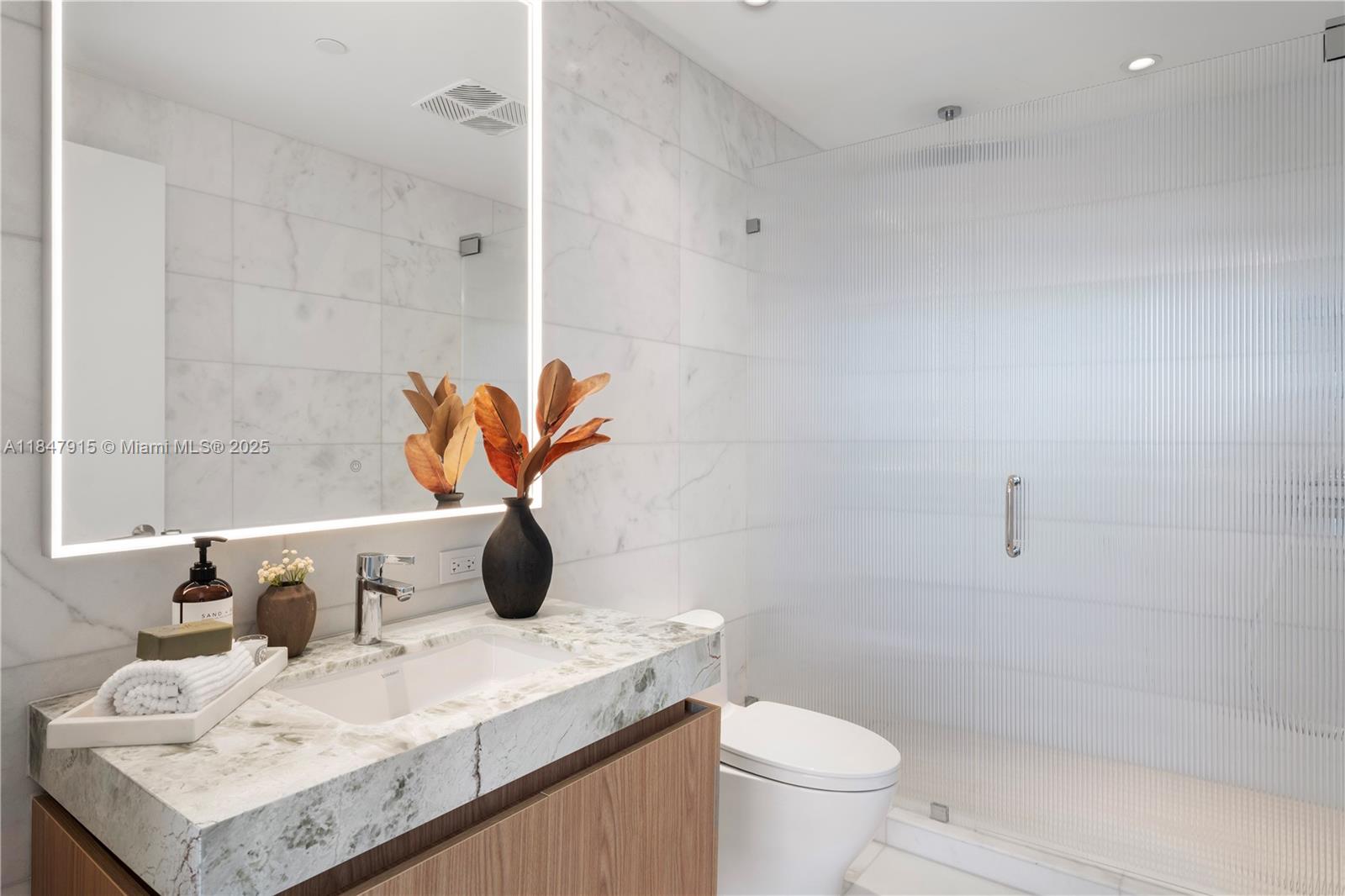 500 Alton Road, Unit 2008 Miami Beach, FL 33139 - Photo 6 of 48 a bathroom with a sink a toilet and a shower