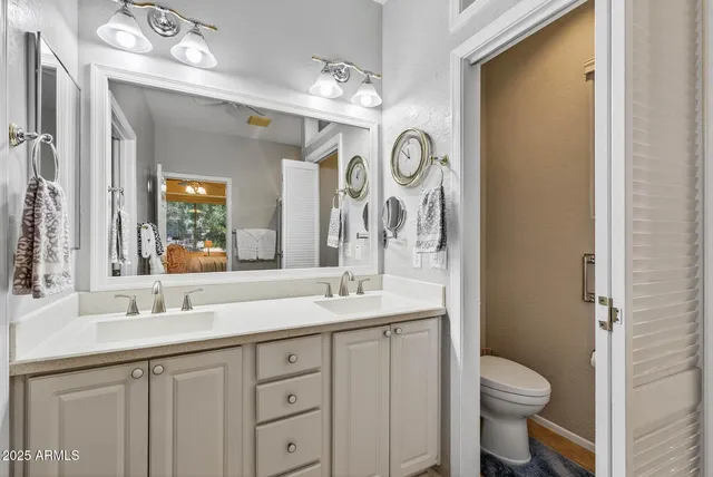 a bathroom with a double vanity sink a mirror and a shower