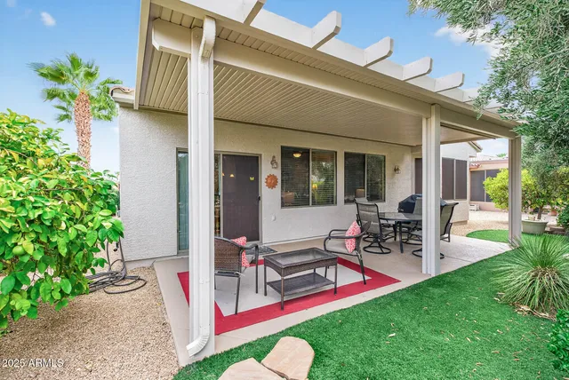 a view of a house with backyard porch and sitting area