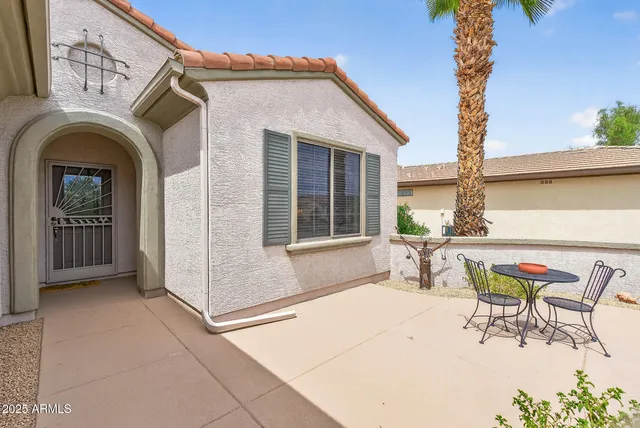 a view of a patio with table and chairs and potted plants