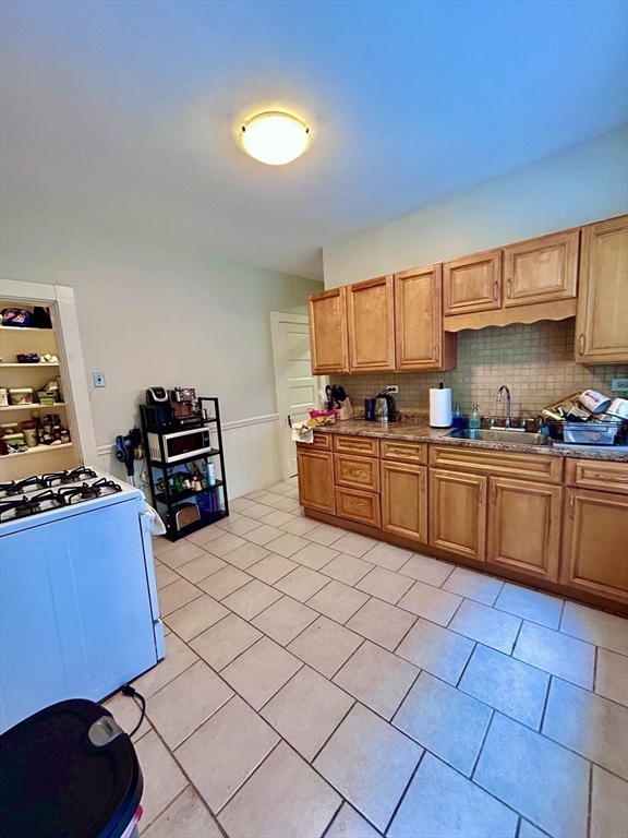 805 Washington Street, Unit 2 Brookline, MA 02446 - Photo 14 of 20 a kitchen with a sink a stove and cabinets