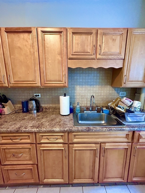 805 Washington Street, Unit 2 Brookline, MA 02446 - Photo 15 of 20 a kitchen with stainless steel appliances granite countertop a sink a stove and cabinets