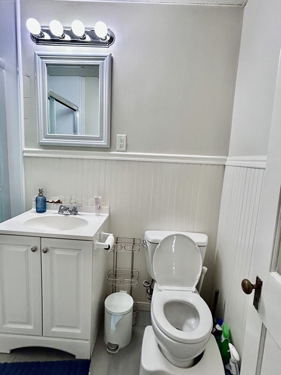 805 Washington Street, Unit 2 Brookline, MA 02446 - Photo 19 of 20 a bathroom with a toilet a sink and mirror