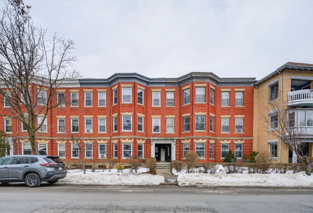 805 Washington Street, Unit 2 Brookline, MA 02446 - Photo 5 of 20 a front view of a building with lot of cars and trees