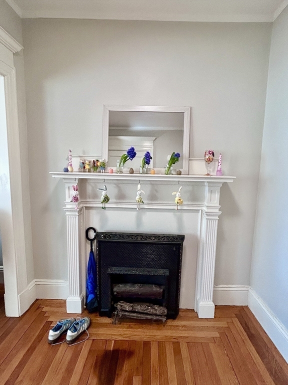 805 Washington Street, Unit 2 Brookline, MA 02446 - Photo 9 of 20 a living room with a fireplace and wooden floor