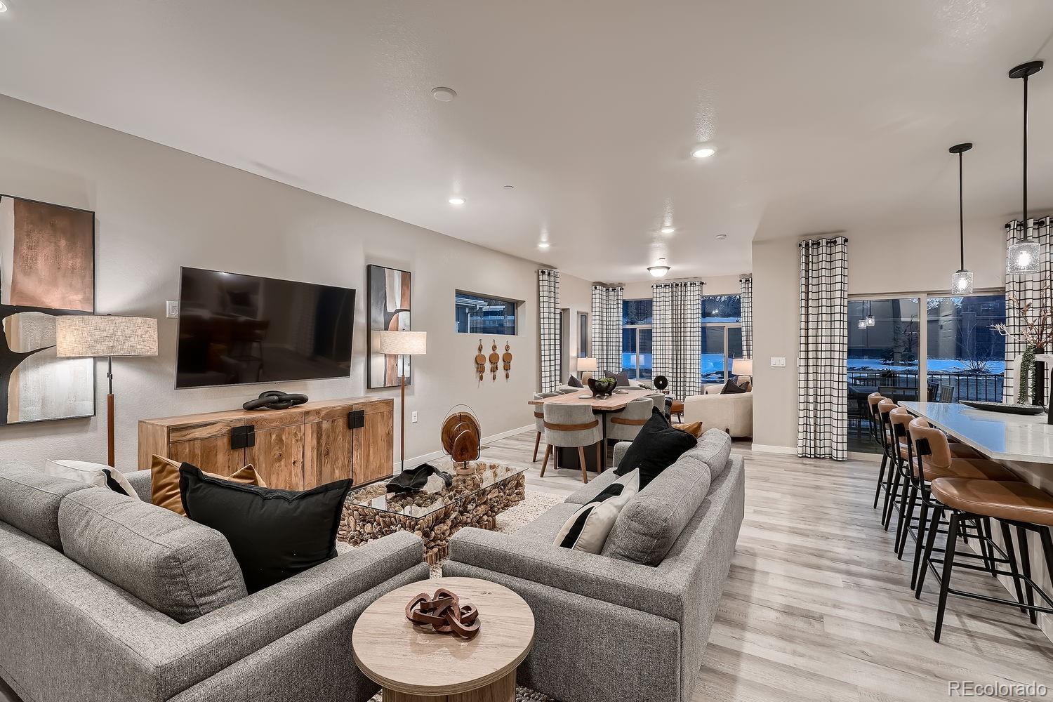 12880 Inca Street Westminster, CO 80234 - Photo 12 of 50 a living room with furniture and a flat screen tv