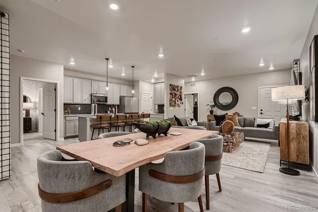 a living room with lots of furniture and kitchen view