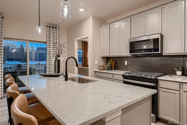 a kitchen with stainless steel appliances granite countertop a stove a sink dishwasher a microwave oven with granite countertops and cabinets