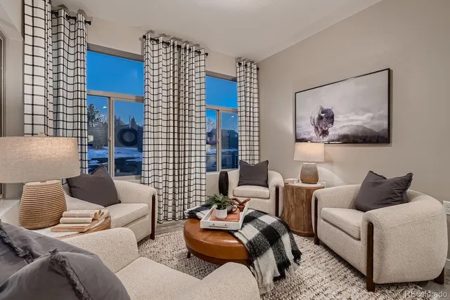 a living room with furniture and a potted plant