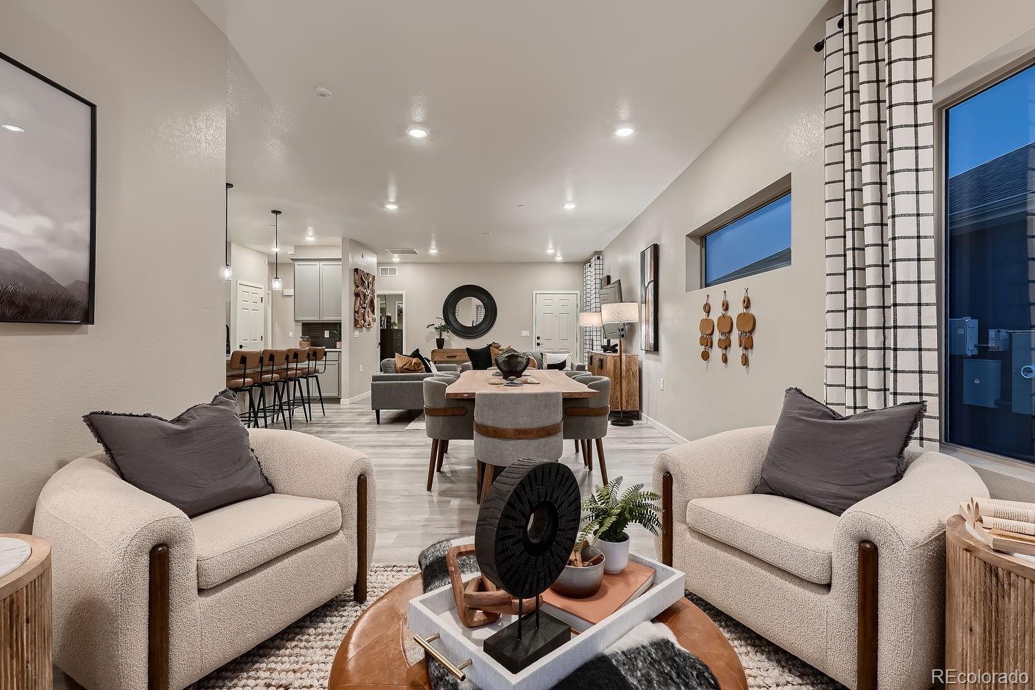 12880 Inca Street Westminster, CO 80234 - Photo 28 of 50 a living room with furniture and a flat screen tv